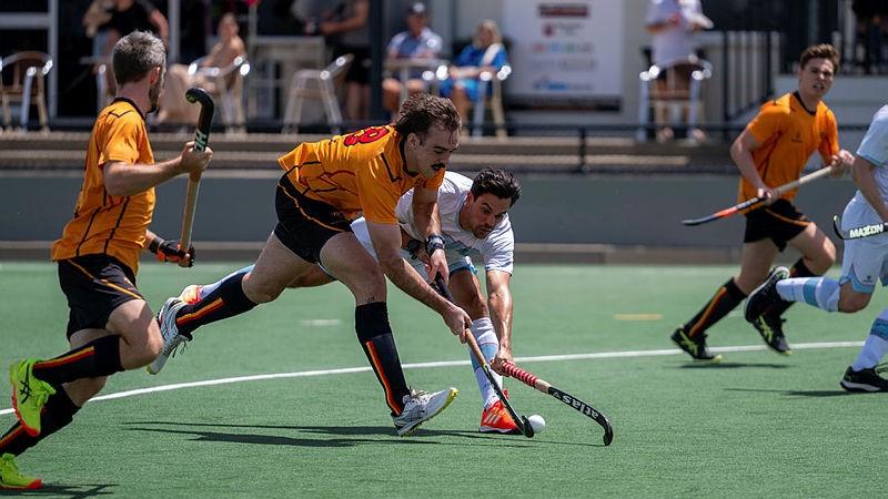 Australian Defence Force hockey player Corporal Jarron Russo defends against an opposing attacker during the Tiger Turf Cup in Brisbane. 