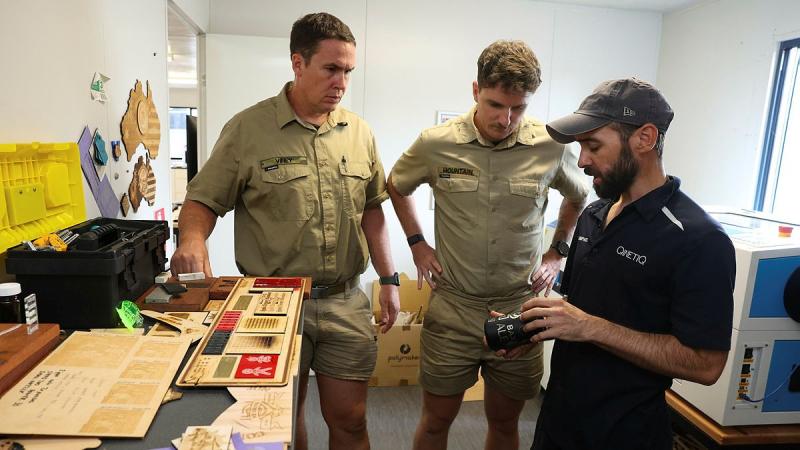 MakerSpace site supervisor Daniel Deleur shows Australian Army Craftsmen Edward Viney and Dylan Mountain things people have made, during a site induction at the MakerSpace on Robertson Barracks.