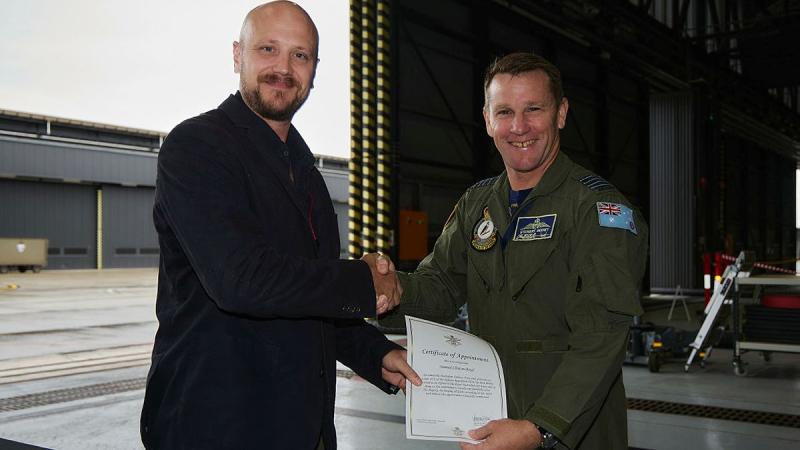 Sam Boyd receives his Certificate of Appointment from Officer Commanding 81 Wing, Group Captain Stewart Seeney, during a ceremony at RAAF Base Williamtown.