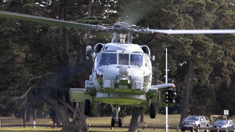 A Royal Australian Navy MH-60R Seahawk helicopter lands at Geelong High School during a visit to meet the students and conduct a presentation about the aircraft.