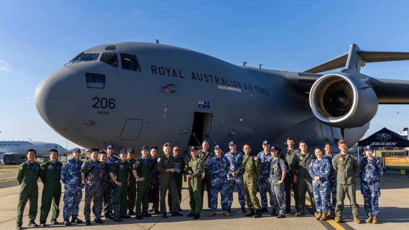 Aviators of the Royal Australian Air Force with members of the Japanese Self Defence Force in front of a Royal Australian Air Force C-17A Globemaster aircraft at the Australian International Airshow 2025.