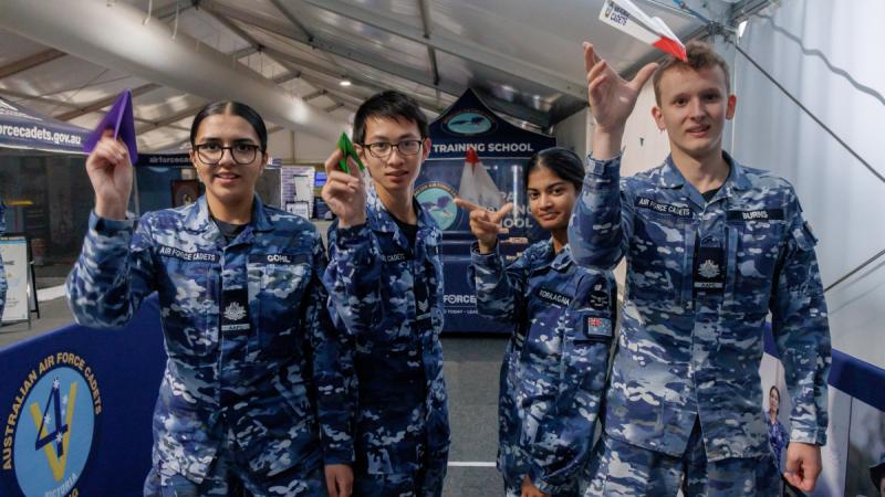 (L-R) Cadet Warrant Officer Mahi Gohil, Cadet Sergeant Fergus Yim, Cadet Under Officer Janethri Koralagma and Cadet Warrant Officer Jackson Burns throw paper planes during the Australian International Airshow 2025 at Avalon.