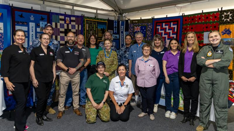 Members representing various defence and veteran support organisations at the Defence Community Tent gather around during the Australian International Airshow, Avalon Airport, Victoria.