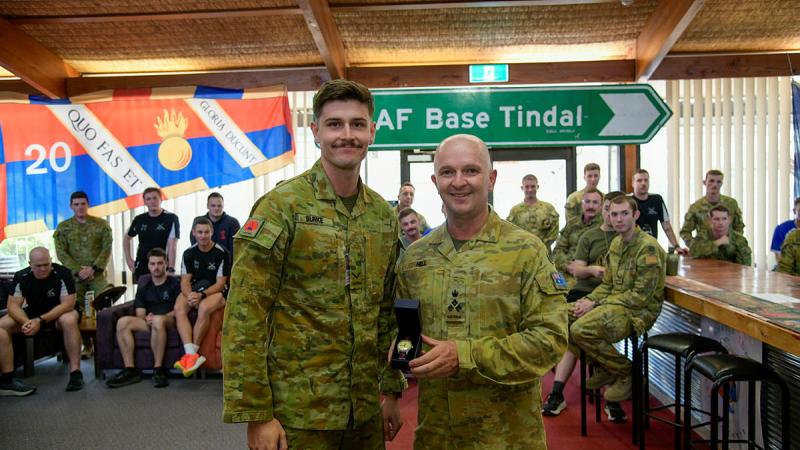 Australian Army officer Brigadier Damian Hill presents Lance Bombardier Joshua Burke with an engraved watch in recognition of the Mattner Award. 