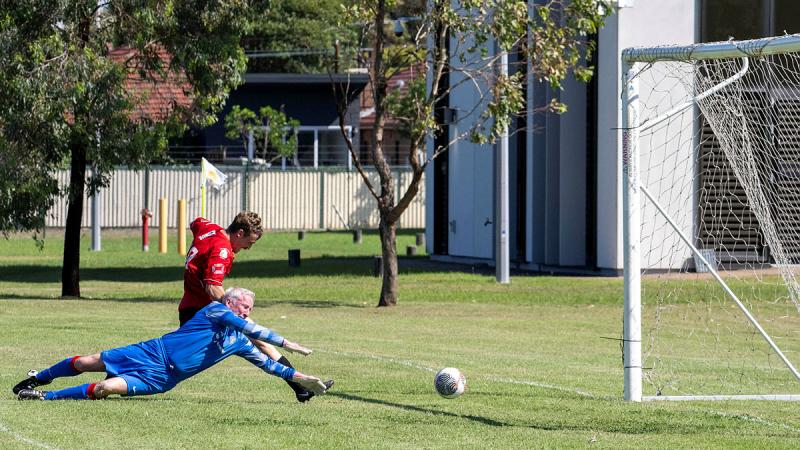 Sapper Bailey Vickers shoots for goal against the British Army Crusaders during a football match at Randwick Barracks. 