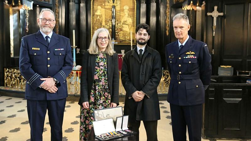 Wing Commander Rich MacNeil, Sally O’Shaugnessy, her son Joe O’Shaugnessy and Group Captain Lewis Frederickson with the medals of Squadron Leader Francis Smith, MC, DFC.