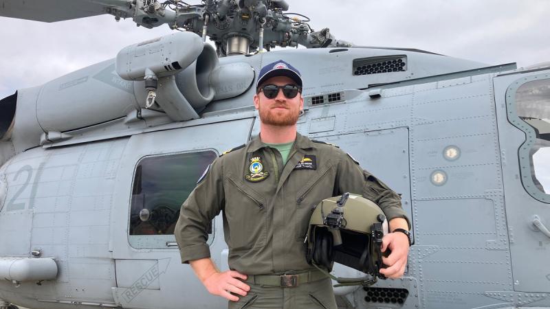 Sub Lieutenant Nicholas Mudge, of Fleet Air Arm's 725 Squadron, in front of a MH-60R Seahawk helicopter. Sub Lieutenant Mudge works as an Aviation Warfare Officer across the fleet's MH-60R Seahawks.