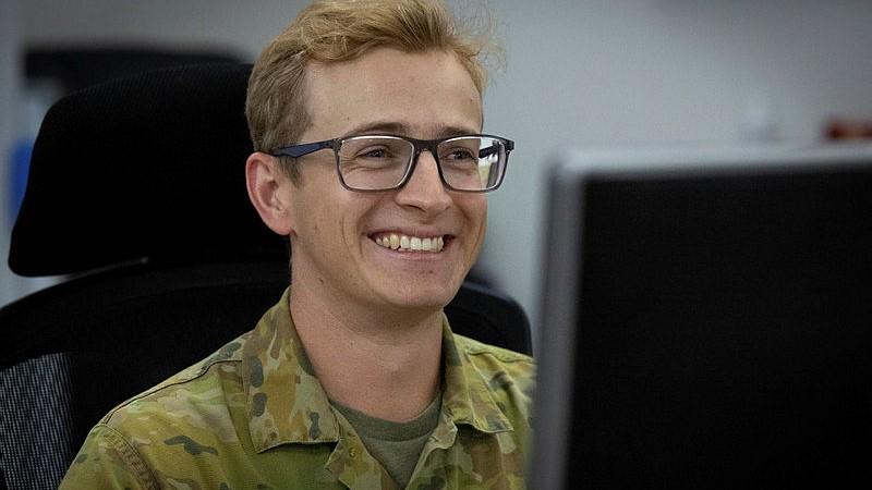 Royal Australian Air Force officer Flight Lieutenant Zac Pattison at his computer while deployed on Operation Accordion at Headquarters Middle East in 2025. 