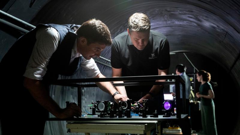 Defence Science and Technology Group scientist Dr Ben Sparkes left, works with Australian-built quantum clocks at the University of Adelaide. He is now part of a research project to create and deliver a ground-to-satellite optical quantum link.