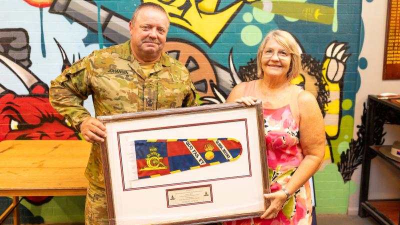 Warrant Officer Class Two Kim Johansen stands alongside his wife, Michelle, after being presented the Federation Star clasp to his Defence Long Service Medal for 40 years of service, at Gallipoli Barracks, Queensland.