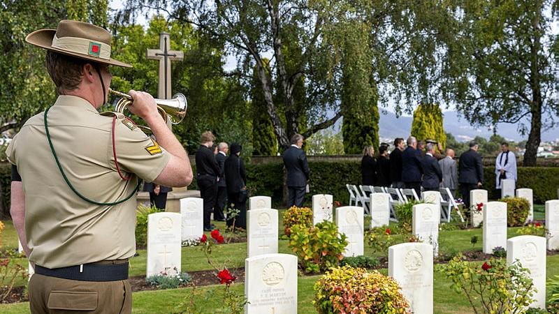 Australian Army Band bugler Corporal Joshua Young sounds the Last Post during the reinterment ceremony for World War I veteran Private Edward Ruffels at the Hobart War Cemetery in Tasmania.