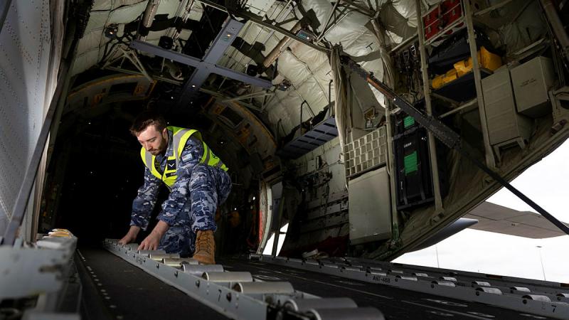 RAAF 37 Squadron Warehouse Storeperson Leading Aircraftman James Jordan installs one of the cargo rollers of a C-130J Hercules aircraft at RAAF Base Richmond, NSW. 
