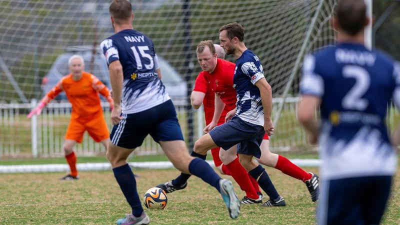 Australian Public Servant Ricky Lee dribbles the ball towards goal for Navy in the match against the British Army Crusaders at HMAS Penguin, Sydney.