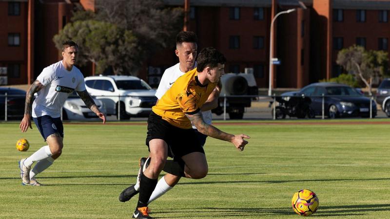 A Western Australian Police officer defends the ball during HMAS Stirling Football Club vs WA Police at HMAS Stirling, WA.