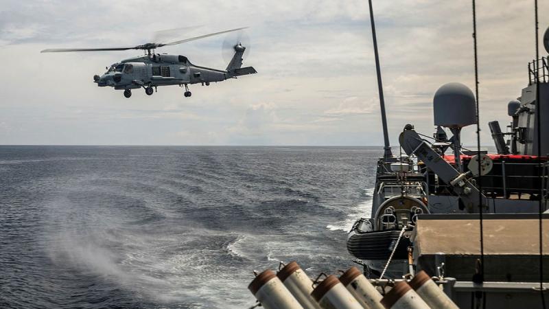 A Navy MH-60R helicopter takes off from HMAS Hobart during ASWEX25 off the WA coast.