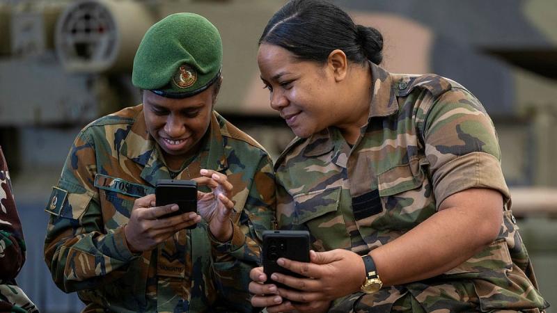 Corporal Loretta Tosusu, from the Vanuatu Mobile Forces, and Warrant Officer Class 2 Sela 'Eva Fifita Finau, from His Majesty's Armed Forces (Tonga), compare images during the International Combined Public Affairs and Photographers course.
