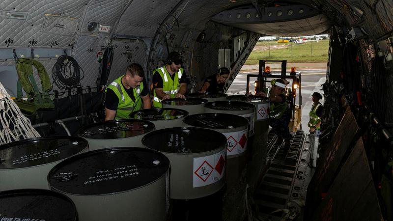 RAAF aviators load fuel stores onto a C-27J Spartan in Longreach, Queensland, Australia. 