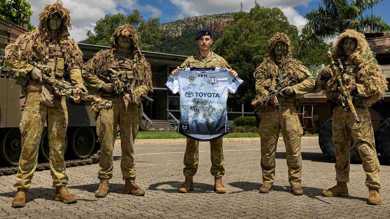 Australian Army soldiers and Corporal Riley Blennerhasset present the 2025 North Queensland Cowboys NRL Defence jersey, at Lavarack Barracks, Townsville. 