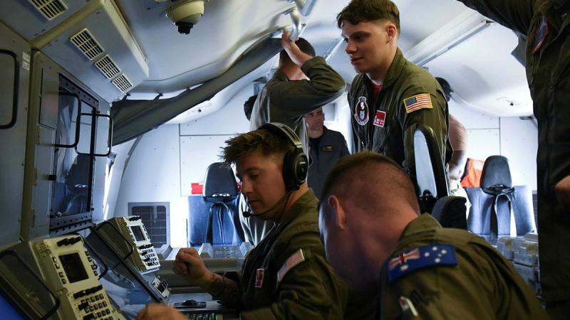 United States Navy Aviation Warfare Operator 2nd Class Thomas Feldman and Royal Australian Air Force Flying Officer Cooper McCall conduct preflight checks aboard a P-8A Poseidon during Exercise Sea Dragon 2025. 