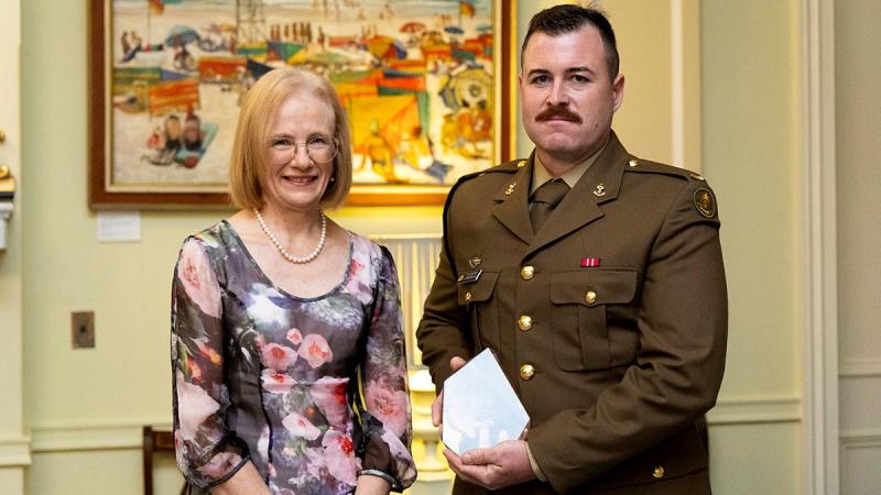 The Governor of Queensland, Dr Jeannette Young, presents Australian Army Sapper Christopher Yarrow of 11th Engineer Regiment the Prince of Wales Award at Government House, Brisbane.