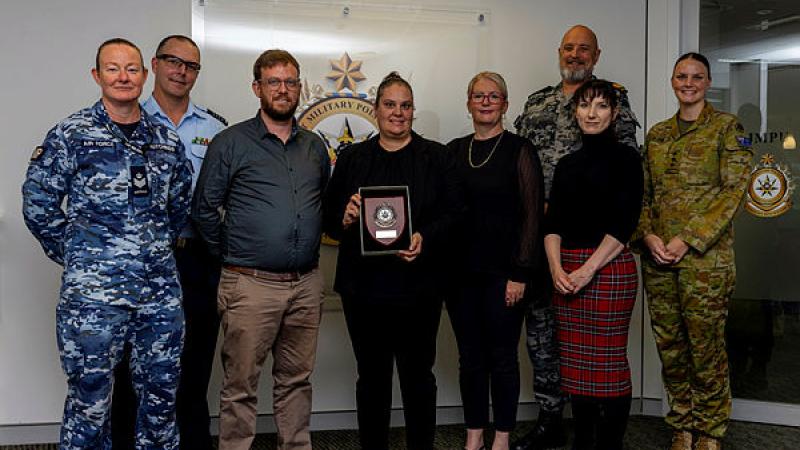  Deaf APS staff at Joint Military Police Unit Headquarters Canberra are presented a plaque of appreciation for their work in records management. 