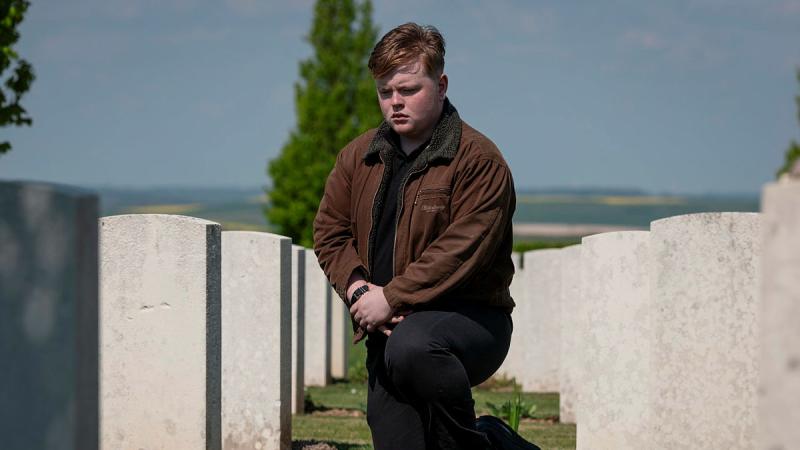 Australian Air Force Cadet Warrant Officer Will Colebrook pays his respects at the headstones of fallen Australian Army soldiers from World War I at Villers-Bretonneux Military Cemetery, France. 