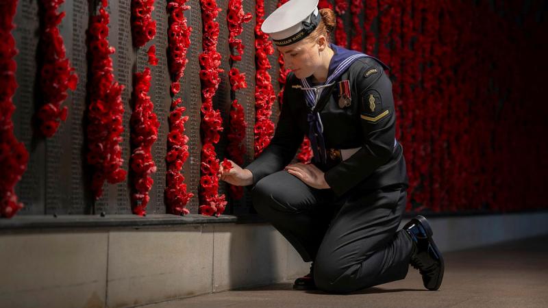 Able Seaman Rachel Brandt of Australia's Federation Guard places a poppy to mark her respects at the Australian War Memorial during the lead-up to Anzac Day 2025.