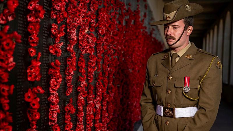 Private Luke Morrison, of Australia's Federation Guard, takes a moment to pay his respects at the Wall of Remembrance at the Australian War Memorial in Canberra. 