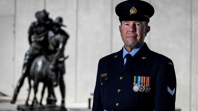 Air Force Corporal Kevin Jefferies of Australia's Federation Guard reflects at the statue of Simpson and his Donkey at the Australian War Memorial before heading to Lone Pine for Anzac Day 2025.