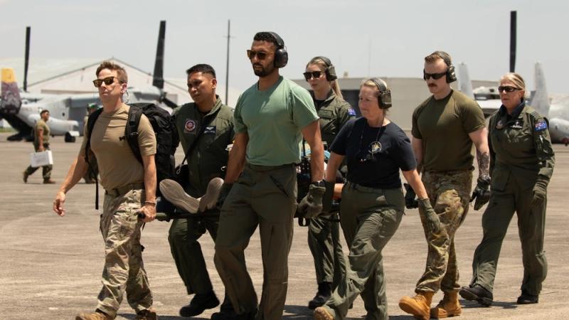 Philippine Air Force members, Royal Australian Air Force aviators and US airmen conduct a litter carry for an aeromedical evacuation exercise in support of Exercise Balikatan 25, at Clark Air Base, Pampanga, Philippines. 