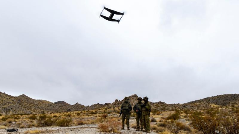 Australian soldiers operate an Unmanned Aerial Vehicle, or drone, as part of the 'Hyper-Teaming' experiment at Project Convergence Capstone 5, at Fort Irwin, California. 