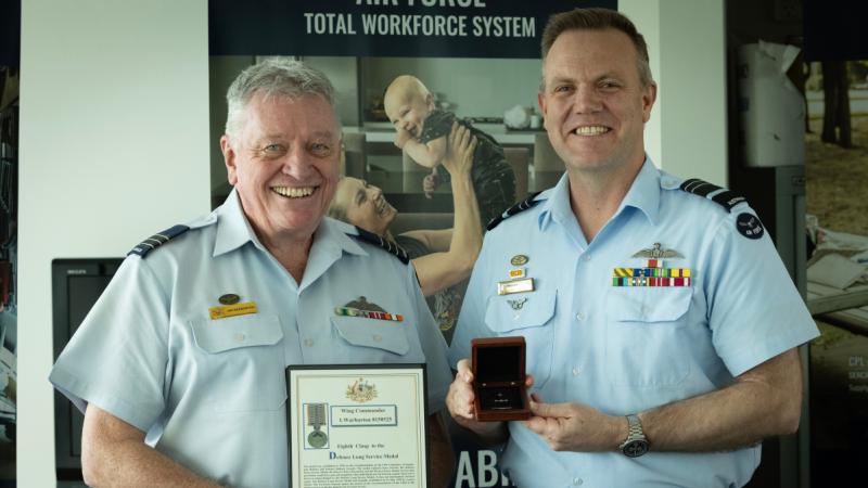 Wing Commander Ian Warburton receives an eighth clasp to his Defence Long Service Medal from Chief of Air Force Air Marshal Stephen Chappell.