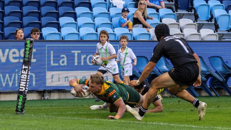 RAAF aviator Leading Aircraftman Izak Ford, of 1 Squadron, dives over the line to score a try for the ADF team.