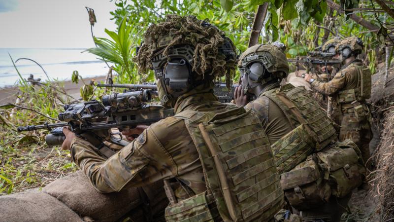 Australian Army soldiers from 5th/7th Battalion, the Royal Australian Regiment, prepare to engage during the counter-landing live-fire exercise at Campong Ulay.
