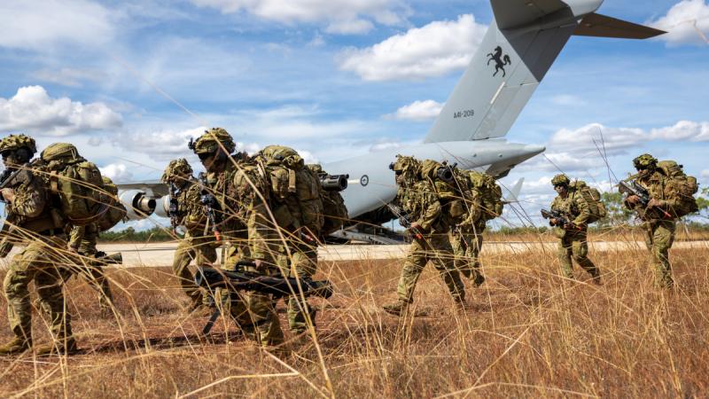 Australian Army soldiers from the 7th Brigade's Battle Group Heeler exit a Royal Australian Air Force C-17A Globemaster III at Nackeroo Airfield as part of Exercise Global Dexterity 25.
