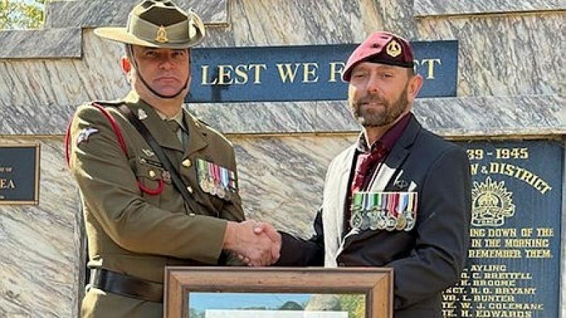 Major Vernon Andrews presents Warrant Officer Class 2 (retd) Gene Cowin with a replacement Warrant in his home town of Batlow on Anzac Day 2025. 