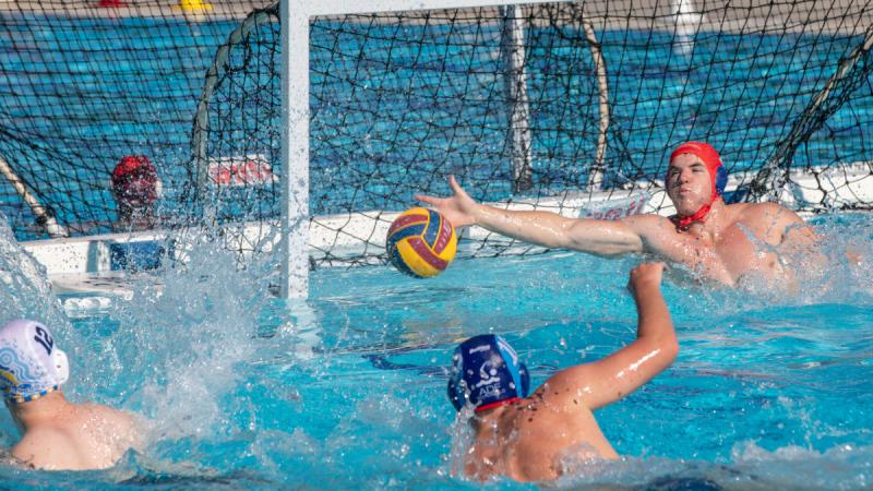 Australian Defence Force Water Polo team goalkeeper, Leading Seaman Scout Warman-Flood, saves a shot on goal while playing the Australian Capital Territory team during the Australian Country Championships on the Gold Coast. 