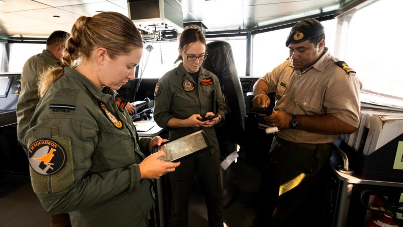 RAAF C-27J Spartan pilots Flying Officer Ashlee Staneke and Flight Lieutenant Kathrine Mitchell coordinate communications with the Captain of the Tonga Royal Navy's Guardian-class patrol boat VOEA Ngahau Siliva.