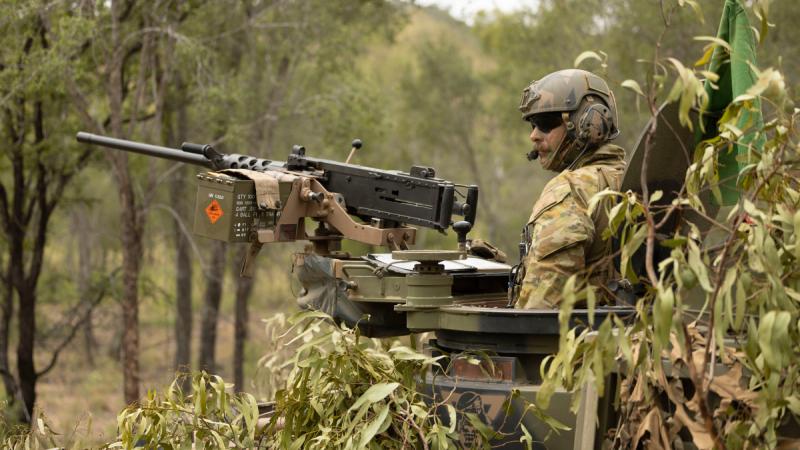 A soldier from the 2nd Cavalry Regiment stands in his Australian Light Armoured Vehicle before a live-fire serial in the Townsville Field Training Area during Exercise Eagle March.