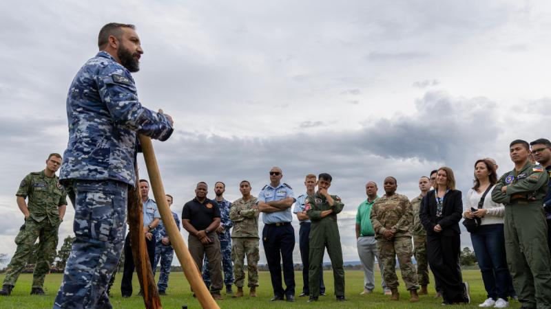 Royal Australian Air Force Indigenous Liaison Officer, Sergeant Ron Schultz, talks to participants of the C-130 and Fighter Aircraft Logistics and Safety Symposium during a cultural immersion activity at RAAF Base Richmond, NSW.