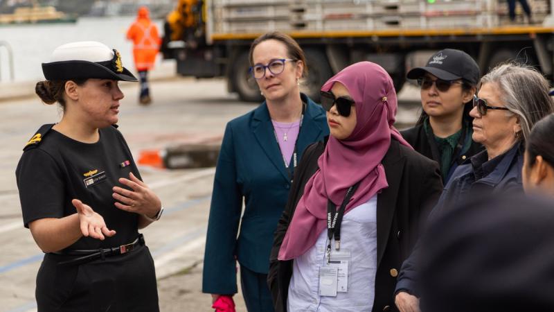 Royal Australian Navy officer Sub Lieutenant Olivia Bowker speaks with participants in the Women in Maritime Security program at Fleet Base East, Sydney.