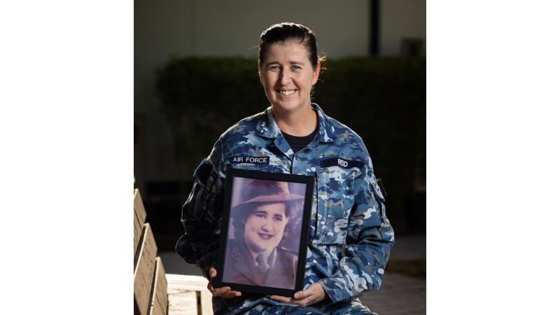 Air Force avionics technician Leading Aircraftwoman Angela Reid holds a photo of her grandmother, Evelyn Collard, who served as a signals telephonist in the Australian Army.