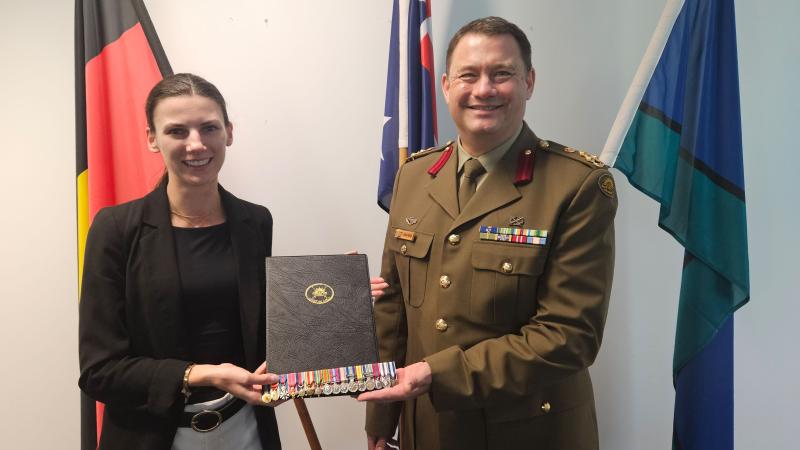 Deputy Surgeon General ADF and Head of the Royal Australian Army Medical Corps, Brigadier Isaac Seidl, presents Sir ‘Weary’ Dunlop’s granddaughter, Dianna, with a set of miniature medals.