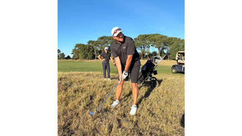 Lieutenant Commander Justin Martin plays from the rough at Royal Adelaide Golf Club, Adelaide.