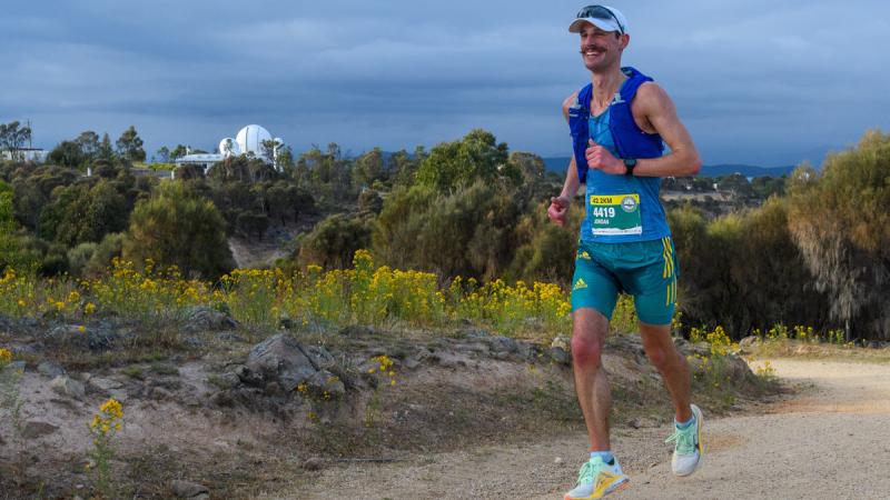 Flight Lieutenant Jordan Cowley reaches the top of Mount Stromlo for the first time in the 2024 Stromlo Running Festival Marathon.