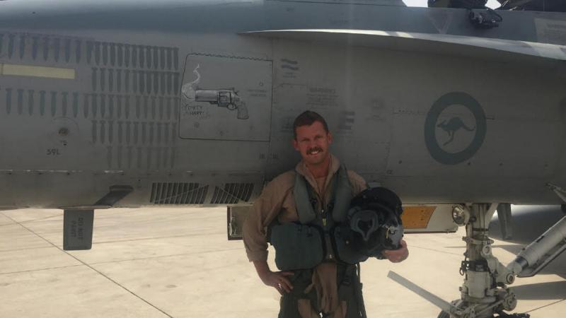 Then-Squadron Leader Ray 'Homer' Simpson, Executive Officer 3 Squadron, on Operation Okra, in front of his F/A-18A Classic Hornet featuring 'Dirty Harry smoking gun' nose art hand drawn by Corporal Patrick Kelly after Homer's strafe pass, the first by a 3 Squadron aircraft since World War II.