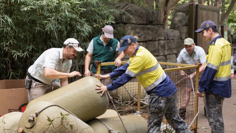 Royal Australian Navy personnel and Taronga Zoo staff unload equipment donated by Port Services East, HMAS Kuttabul for the elephants at Taronga Zoo, Sydney.