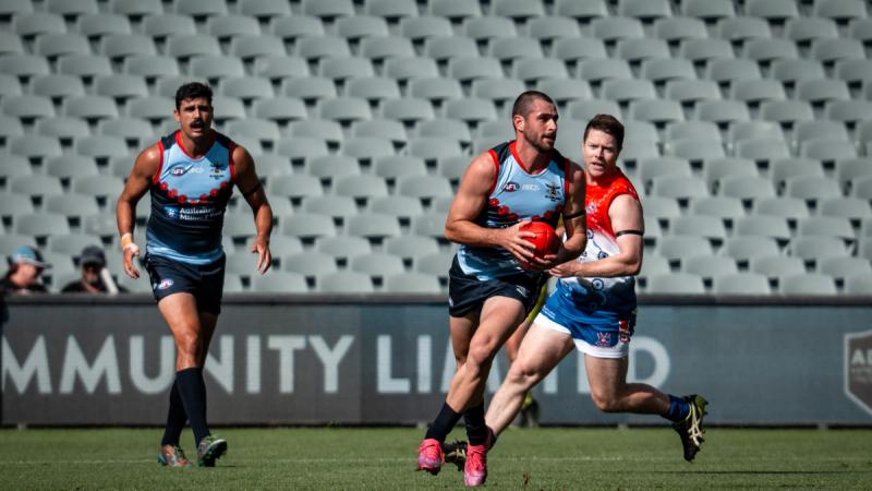 Leading Aircraftman Matthew Borg  Matthew Borg runs with the ball during an exhibition match between the ADF and Australian Combined Emergency Services teams, at Adelaide Oval.