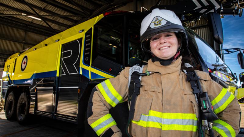 Sarah Barrett visits 26 Squadron fire section, dressed in firefighter's uniform, at RAAF Base Williamtown during the Air Force Aviation Program for Women. 