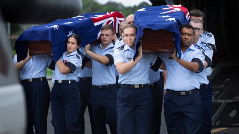 Royal Australian Air Force personnel from Australia's Federation Guard and 100 Squadron carry the caskets of Warrant Officer Russell Grigg and Warrant Officer Clement Wiggins in Port Moresby, Papua New Guinea. 